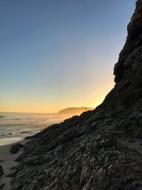 Scenic view of sea against clear sky at sunset