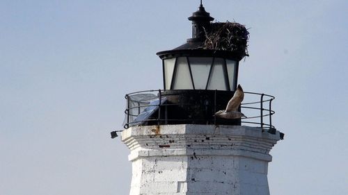 Low angle view of old lighthouse against clear sky