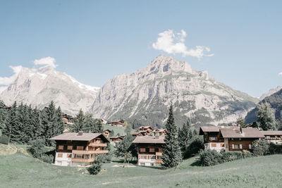 Scenic view of houses and mountains against sky