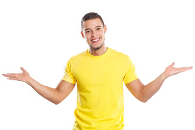 Portrait of smiling young man standing against white background