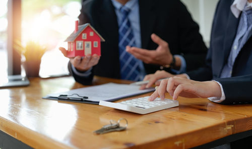 Midsection of business colleagues working on table