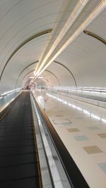 Moving walkway in illuminated tunnel