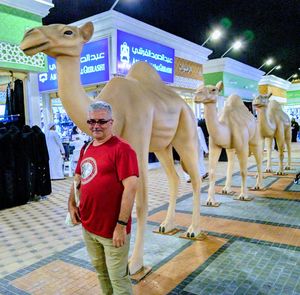 Full length of man standing at illuminated shop