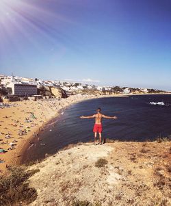 Woman standing on beach against sky