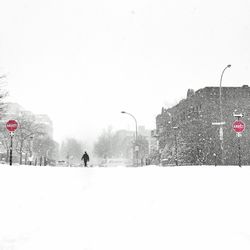 Man on snow covered landscape against sky