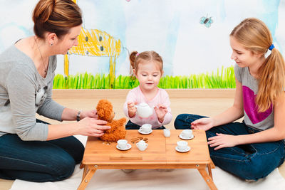 Family having baby tea party