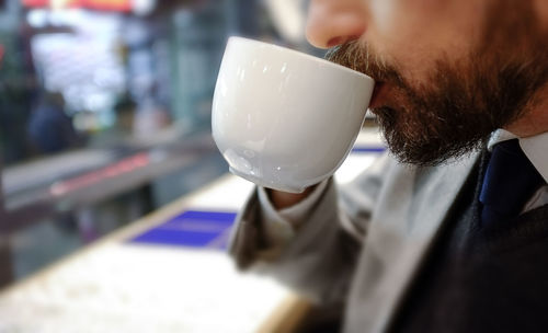 Close-up of man drinking coffee