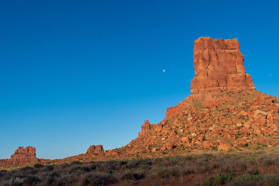 Landscape of red buttes against blue sky in the valley of the gods in utah