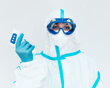 Portrait of man wearing mask against white background