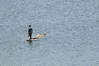 Rear view of man fishing in sea