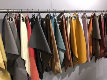 Multi colored umbrellas hanging on rack in store