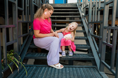 Full length of boy sitting on slide