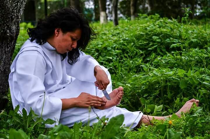 WOMAN SITTING IN A GARDEN