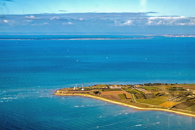 High angle view of bay against blue sky