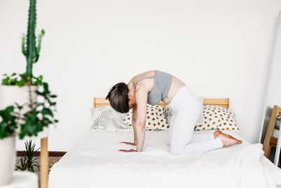 Woman resting on bed at home