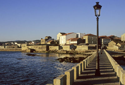 View of buildings against clear blue sky