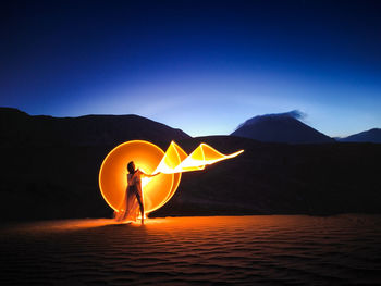 Silhouette person against sky during sunset