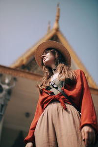 Portrait of woman standing against clear sky