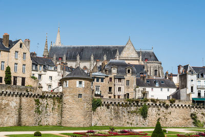 Buildings in city against clear sky