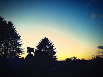 Silhouette trees against sky during sunset