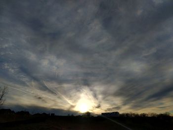 Scenic view of storm clouds over field