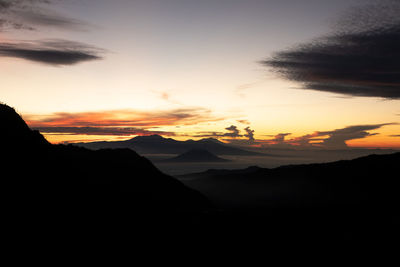 Scenic view of silhouette mountains against sky during sunset