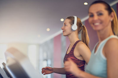 Women exercising on treadmill in gym