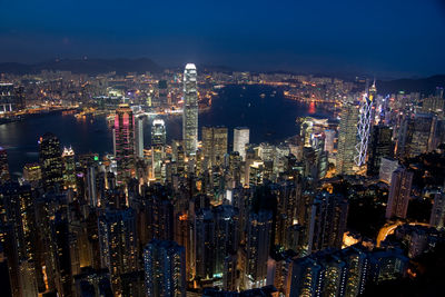 High angle view of illuminated cityscape against sky at night