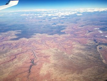 Aerial view of airplane wing over landscape