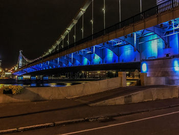 Illuminated bridge at night