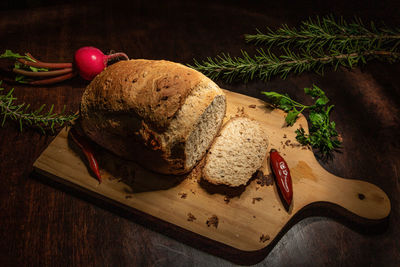 High angle view of bread and vegetables on cutting board