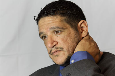 Close-up portrait of man against wall