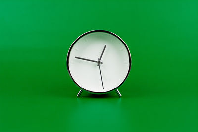 Close-up of clock against blue background