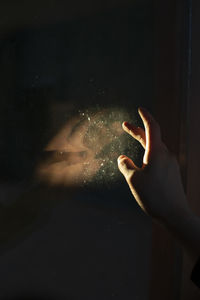 Close-up of hand on illuminated stage