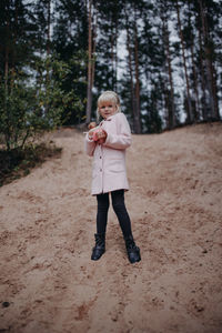 Full length of woman standing in forest