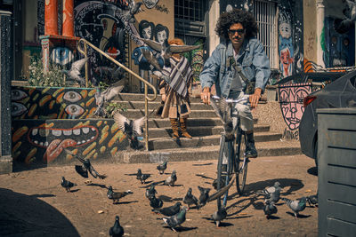 Full length of young man and birds