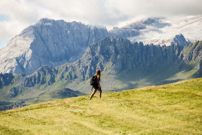 Full length of man skateboarding on mountain against sky