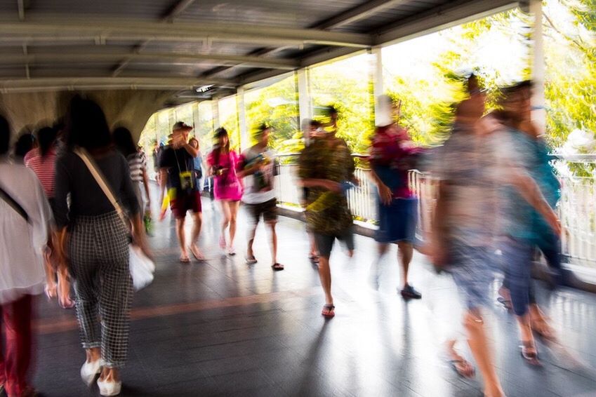 men, indoors, person, large group of people, lifestyles, walking, leisure activity, transportation, blurred motion, medium group of people, full length, public transportation, on the move, group of people, rear view, mixed age range, city life, travel, built structure