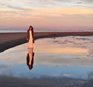 Silhouette of woman standing on beach