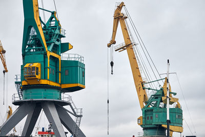 Massive harbor cranes in seaport. heavy load dockside cranes in port, cargo container yard