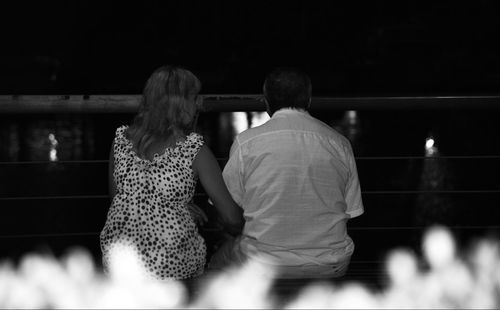 Rear view of woman standing at night