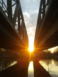 Bridge over river at sunset