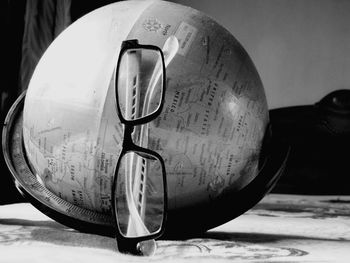 Close-up of sunglasses with ball on table