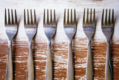 High angle view of forks on wooden table