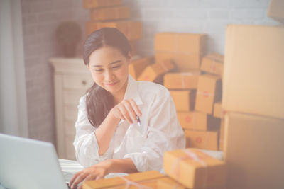 Smiling businesswoman using laptop at table