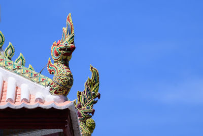 Low angle view of sculpture against building