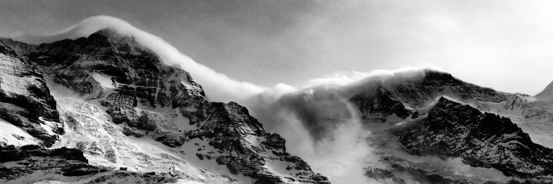 Scenic view of snow covered mountains against sky