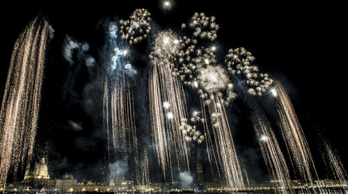 Close-up of illuminated lighting equipment against sky at night