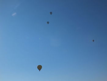 Low angle view of hot air balloon against clear blue sky