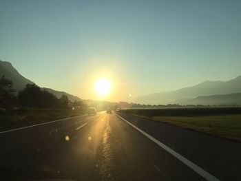 Road amidst landscape against sky during sunset